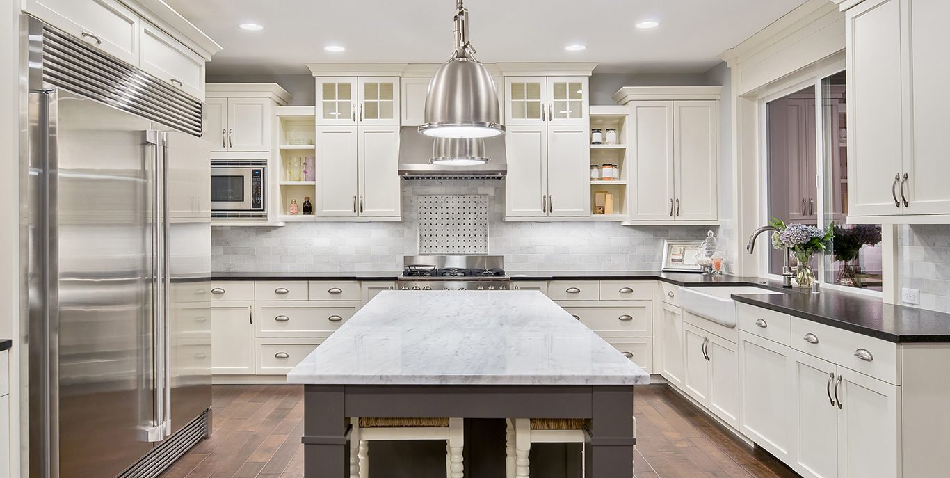 Custom white kitchen with island built by Coomber Construction